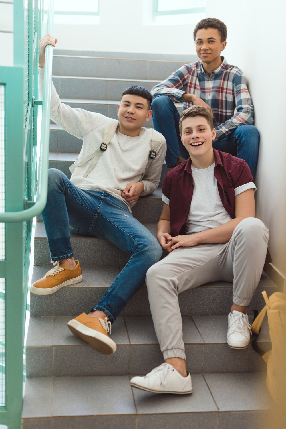 Courses teenage schoolboys sitting on stairs at school and l4mn3ul.jpg